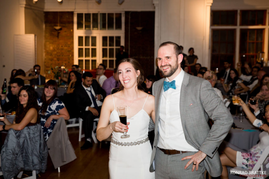 A bride and groom standing together at a wedding reception at Prospect Park.