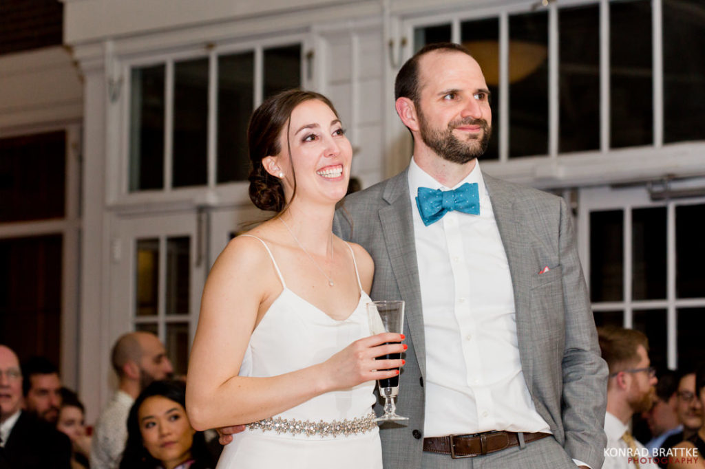 A bride and groom smiling at each other at a Prospect Park wedding reception.