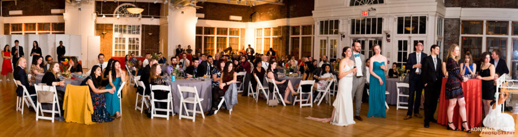 A large group of people at a wedding reception at the Prospect Park Picnic House.