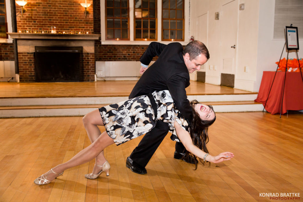 A man and woman dancing in a ballroom.