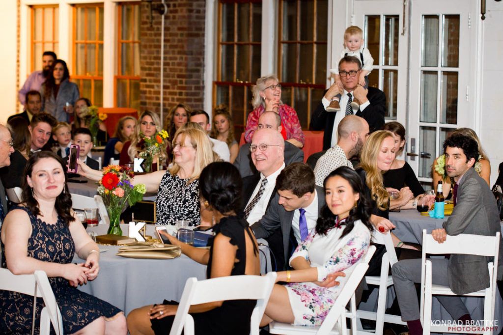A group of people sitting at tables at a Prospect Park Wedding.