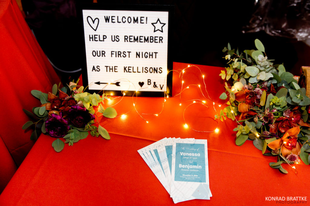 A red table with a sign on it at Prospect Park Wedding.