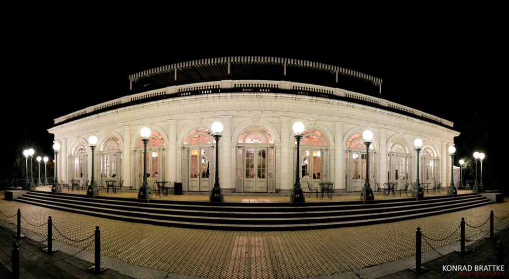 An image of the Prospect Park boathouse lit up at night.
