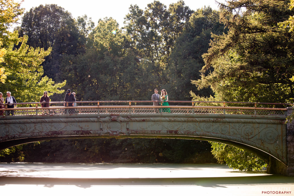 A group of people standing on a bridge in Prospect Park.