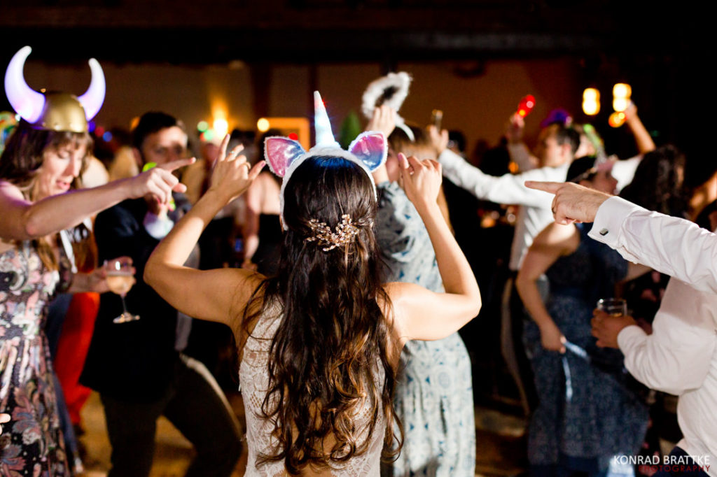 A bride wearing a unicorn horn at the 26 Bridge party.