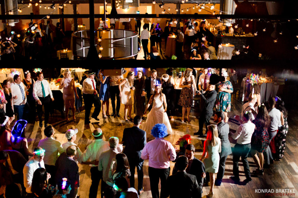 A group of people dancing at the 26 Bridge wedding reception.