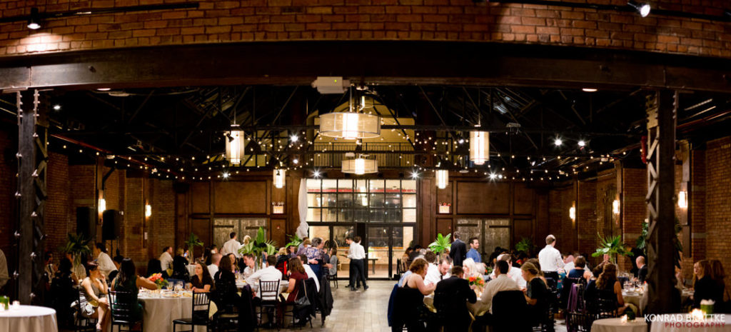 A wedding reception at 26 Bridge, a large room with tables and chairs.