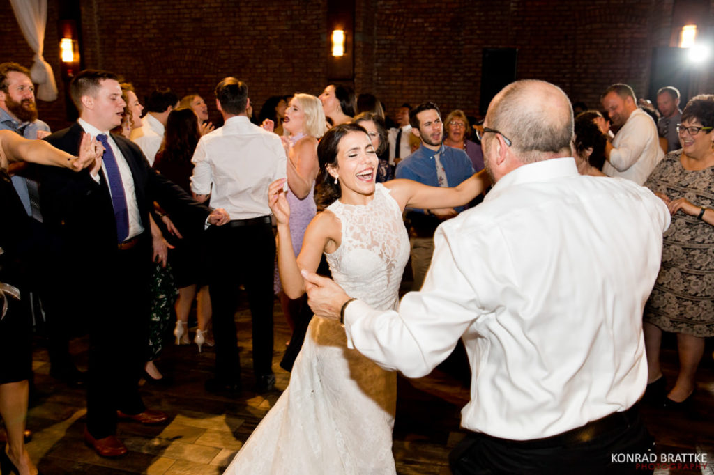 A bride and groom dancing at a wedding reception at 26 Bridge.