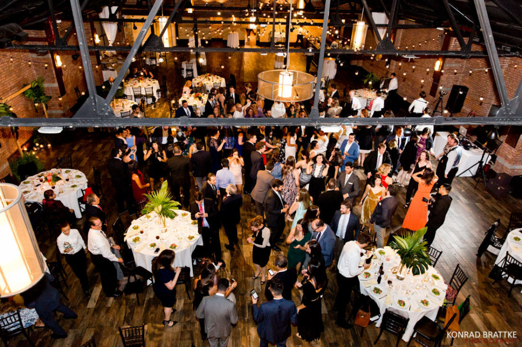 A wedding reception at 26 Bridge, a large room with tables and chairs.