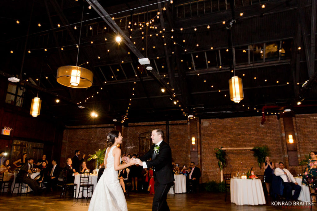 The newlyweds perform their first dance at the grand reception venue, 26 Bridge.
