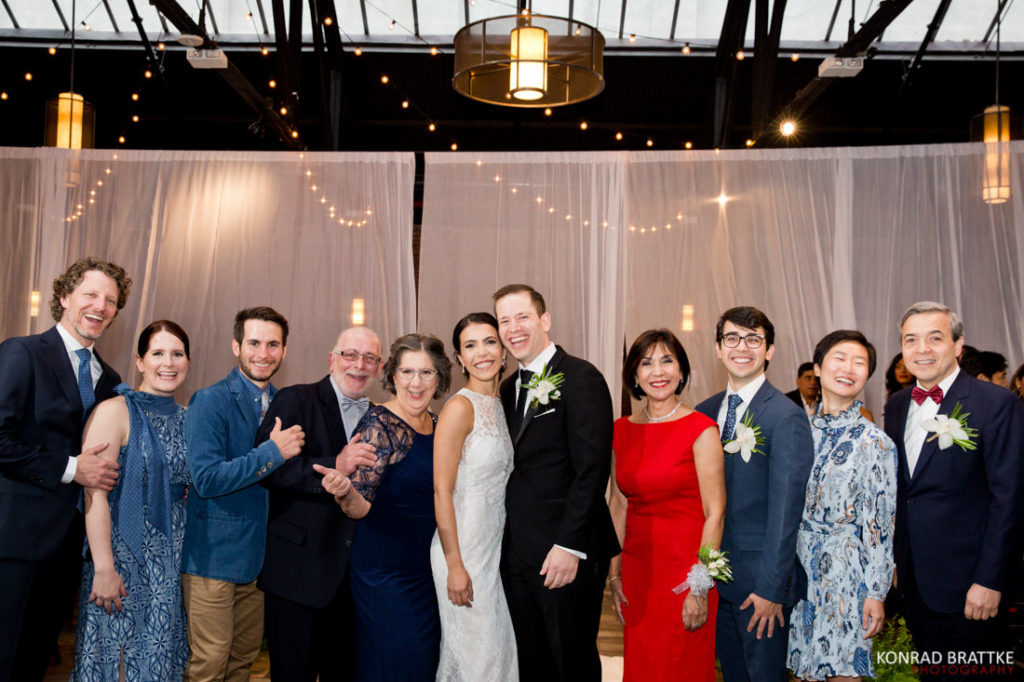 A group of people posing for a photo at the elegant 26 Bridge wedding venue.