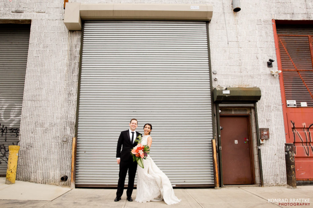 A bride and groom standing in front of a door.