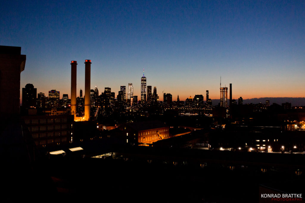 A city skyline at dusk with smokestacks in the background, perfect for a Brooklyn Grange wedding.