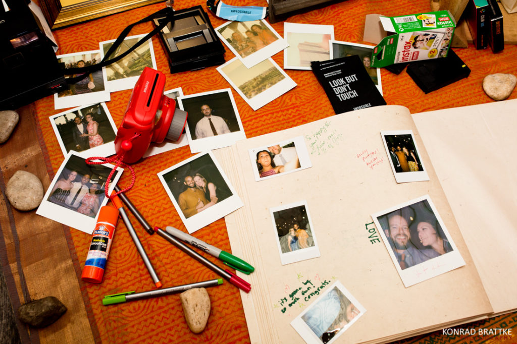 An open book featuring Brooklyn Grange Wedding photos and pens on it.