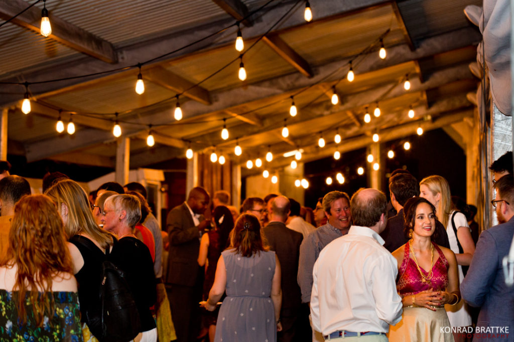 A group of people standing around at a Brooklyn Grange Wedding party.