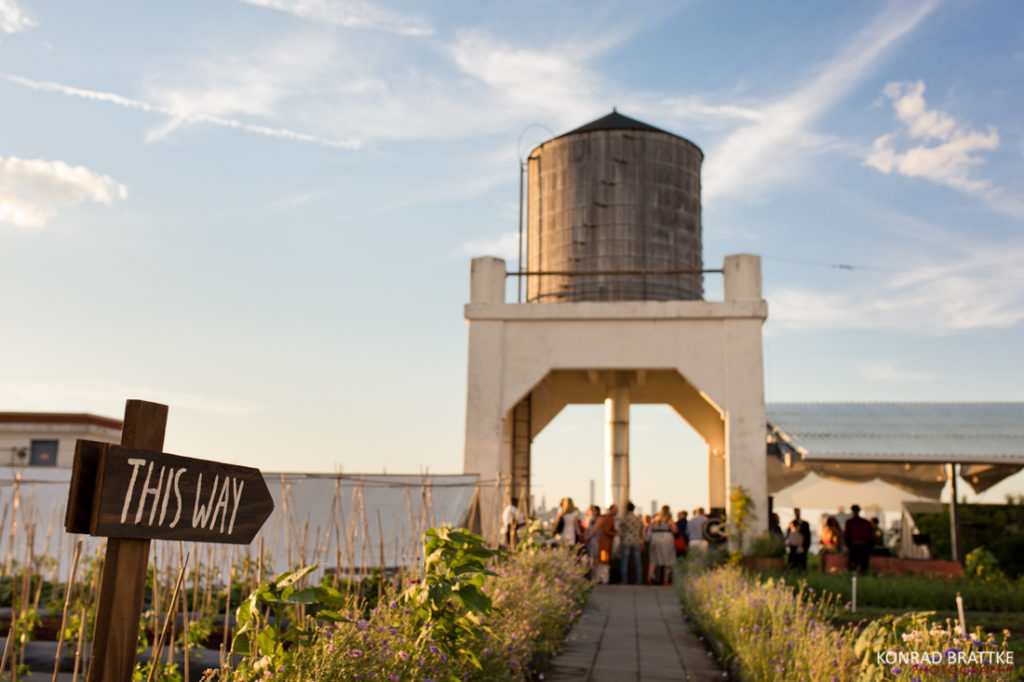 A white water tower located in Brooklyn Grange, a perfect venue for a unique wedding celebration.