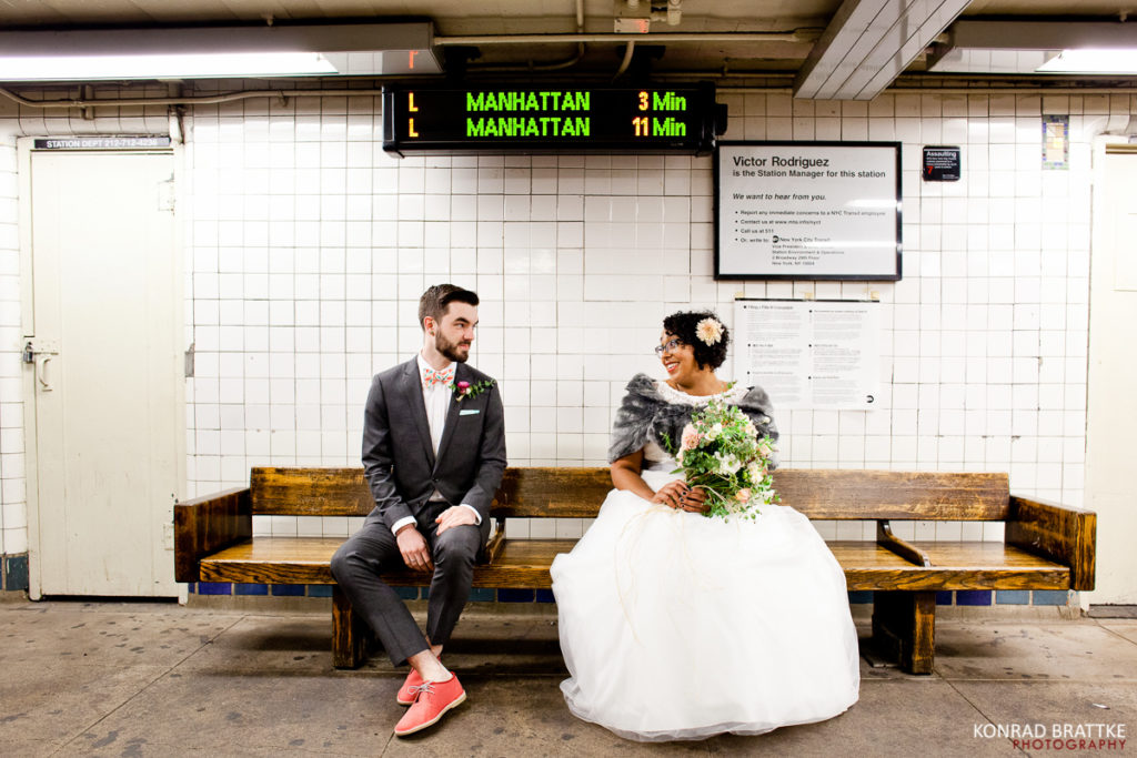A bride and groom sitting on a bench in a subway station in Brooklyn, capturing the essence of their unique Brooklyn wedding.
