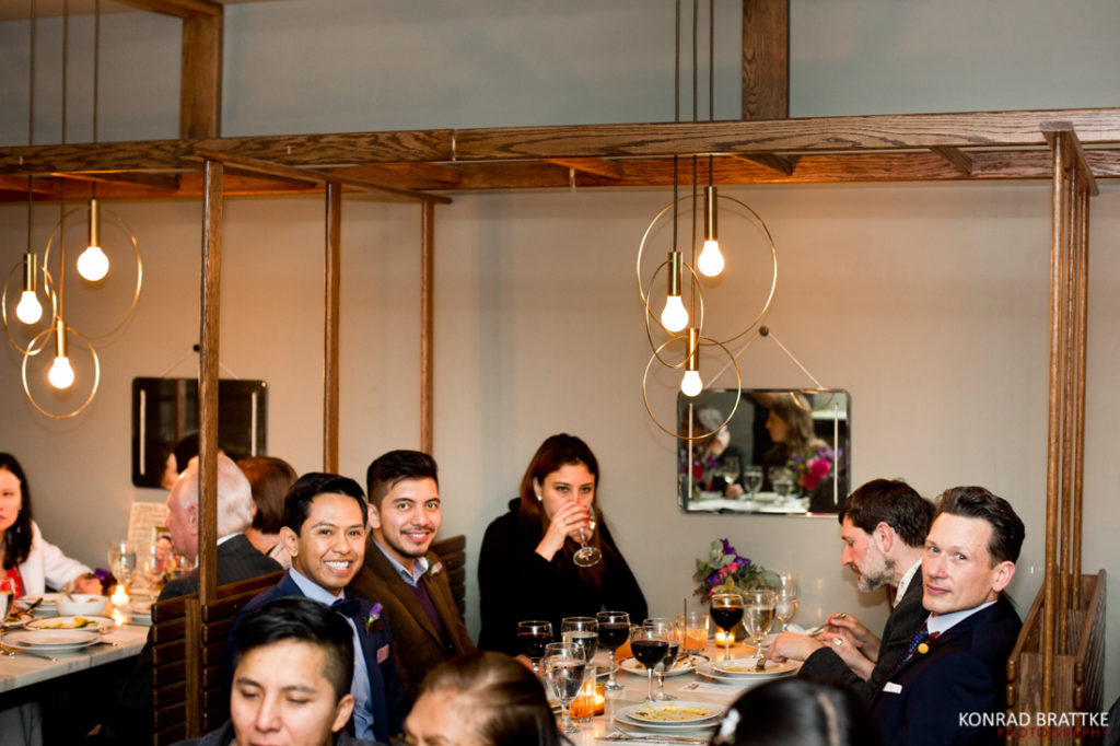 A group of people sitting around a table at Le Fanfare restaurant.