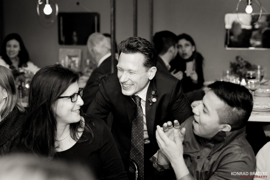 A group of people laughing and enjoying themselves at a Le Fanfare party.