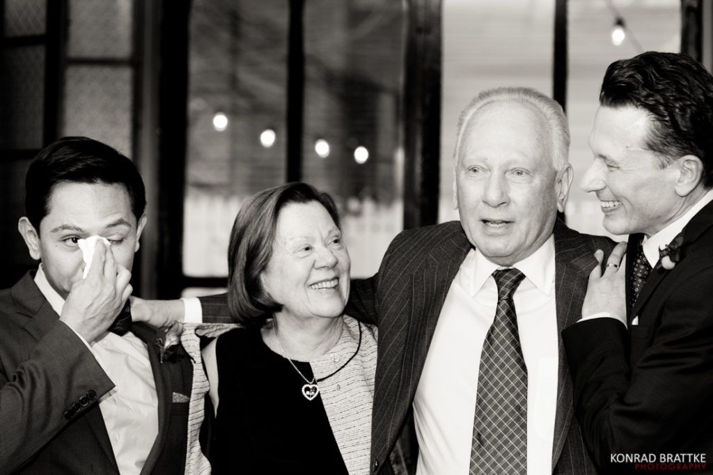 A black and white photo of a group of people posing for a photo at Le Fanfare.