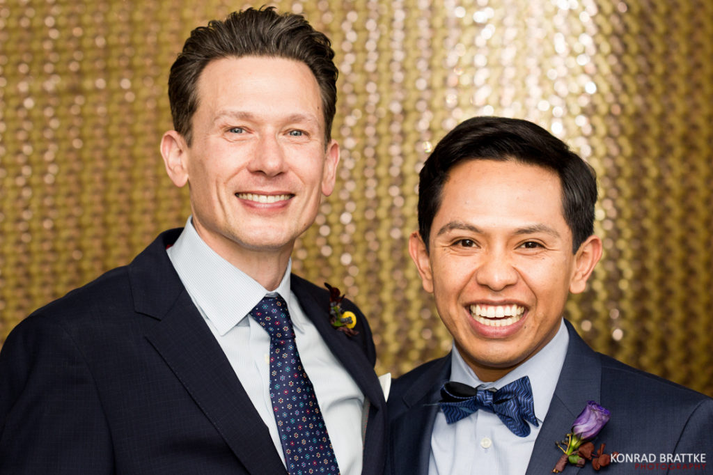 Two grooms posing for a photo at Le Fanfare.