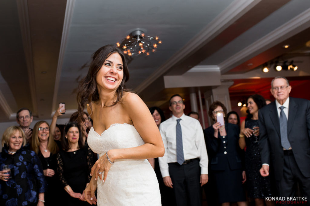 A bride dances with her friends at a Manhattan Penthouse wedding reception.