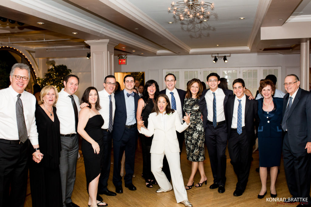 A group of people posing for a picture at a Manhattan Penthouse wedding party.