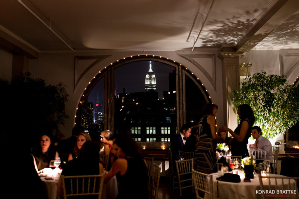 A mesmerizing view of the Empire State Building glowing majestically against the night sky, perfect for a romantic Manhattan penthouse wedding.