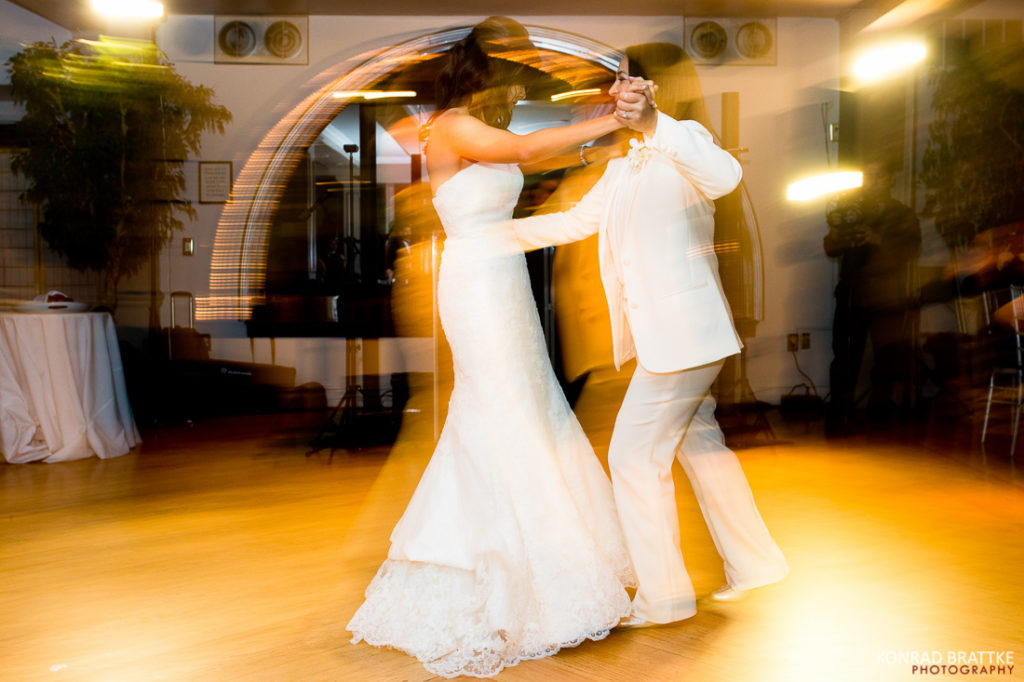 Two brides gracefully dancing on a dance floor at their elegant Manhattan Penthouse wedding.