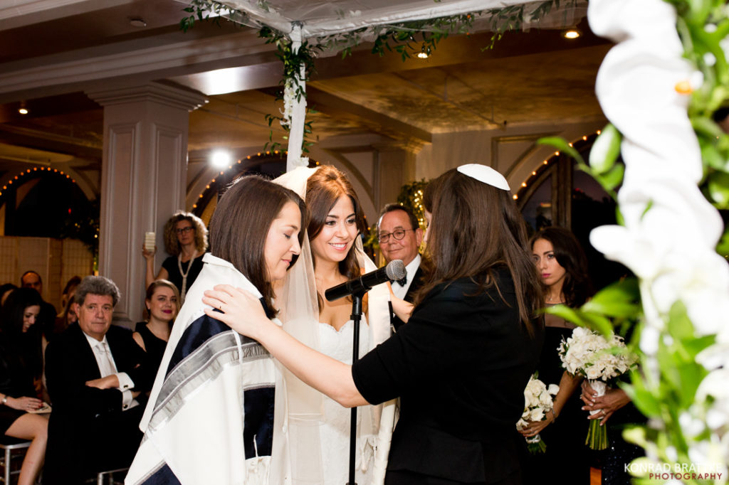 A Manhattan Penthouse wedding ceremony with a two brides, incorporating Jewish traditions.