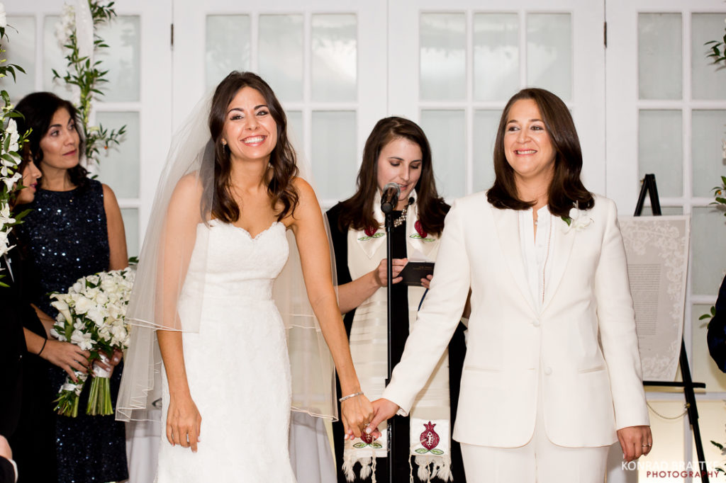 Two women walking down the aisle at a Manhattan wedding ceremony conducted at the elegant Penthouse venue.