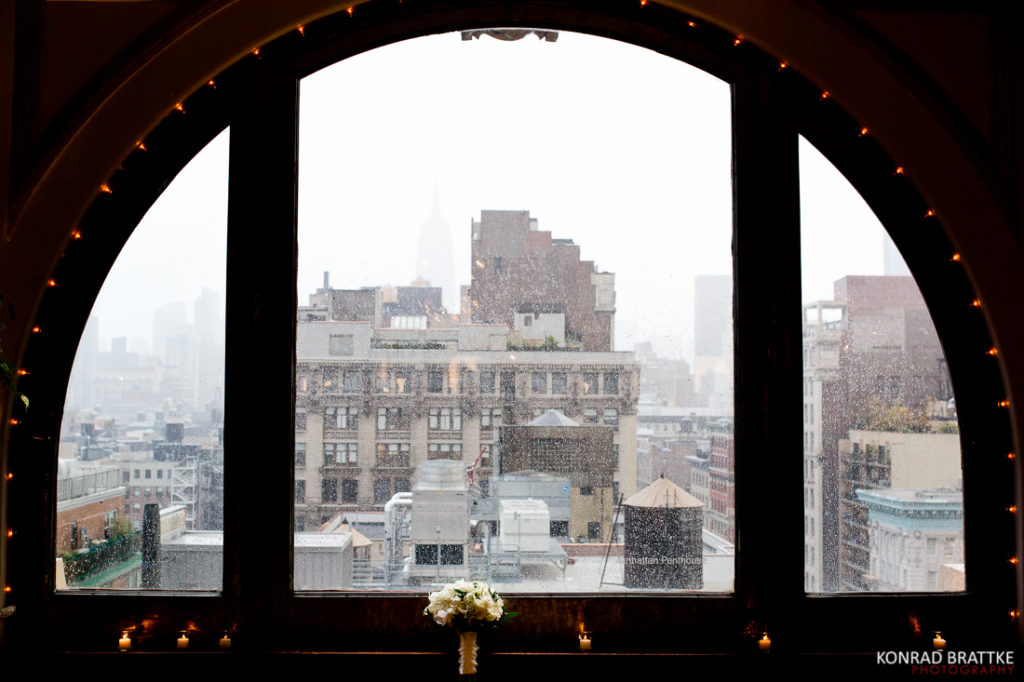 A window with a view of a city, perfect for a Manhattan Penthouse wedding.