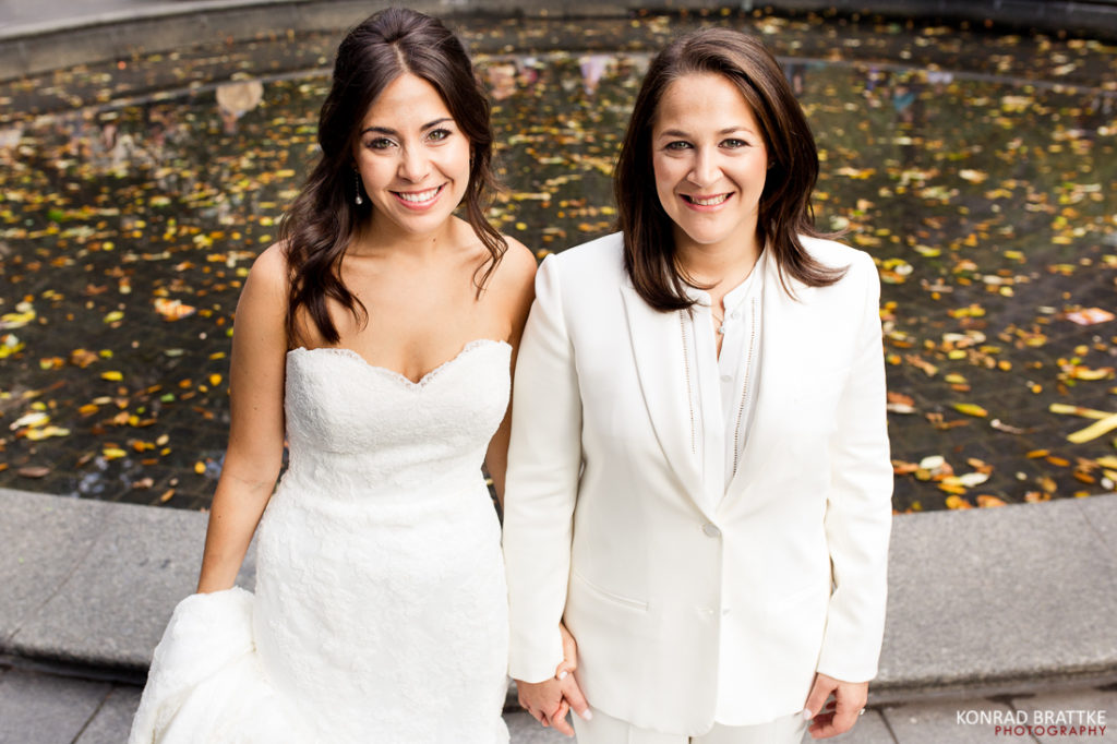 Two brides standing in front of a Manhattan Penthouse wedding.