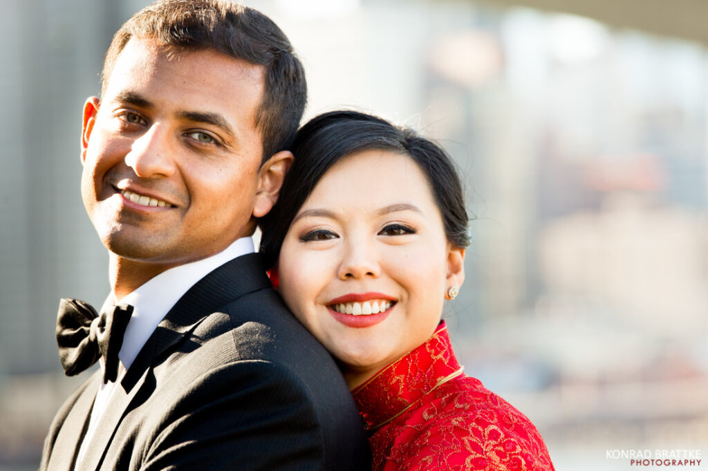 A man and woman elegantly posing for a photo in front of a breathtaking city skyline, capturing the essence of the best of weddings.