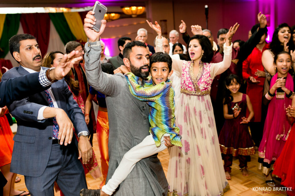 The best of weddings, featuring a group of people dancing at an Indian wedding reception.