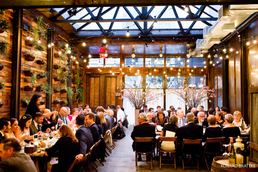A group of people sitting at tables in Brooklyn Winery, a restaurant.
