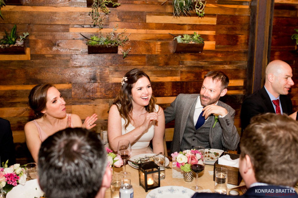 Guests at a wedding reception held at Brooklyn Winery joyously clap to celebrate the newlyweds.
