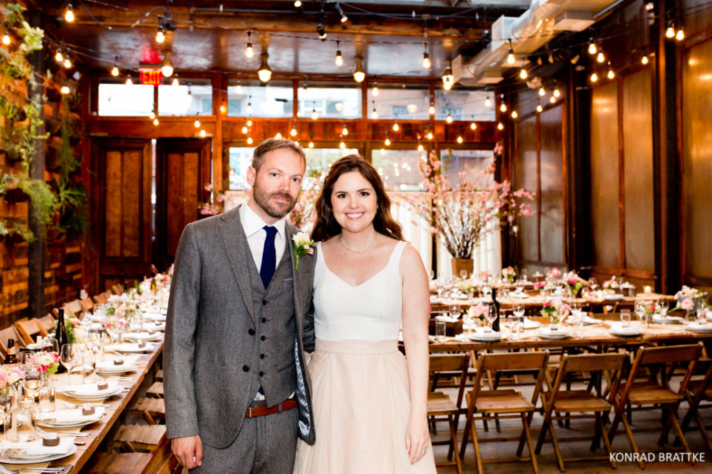 A bride and groom posing for a photo at Brooklyn Winery.