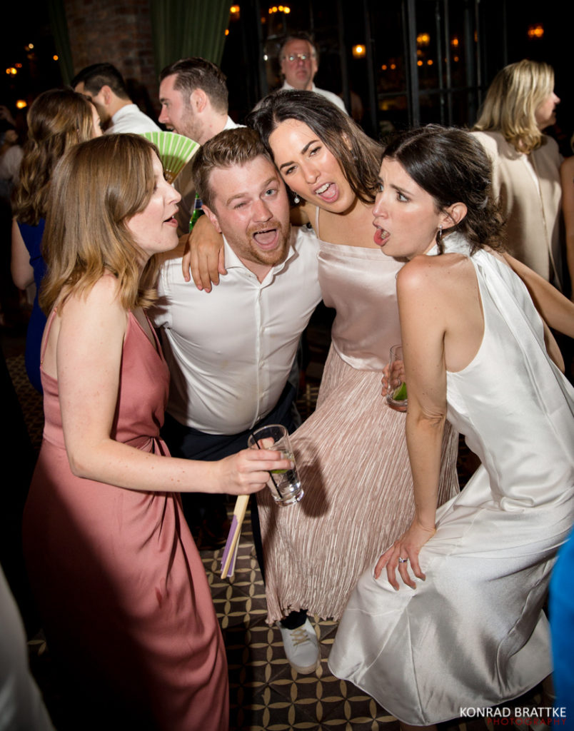A group of people posing for a picture at a wedding at the Bowery Hotel.