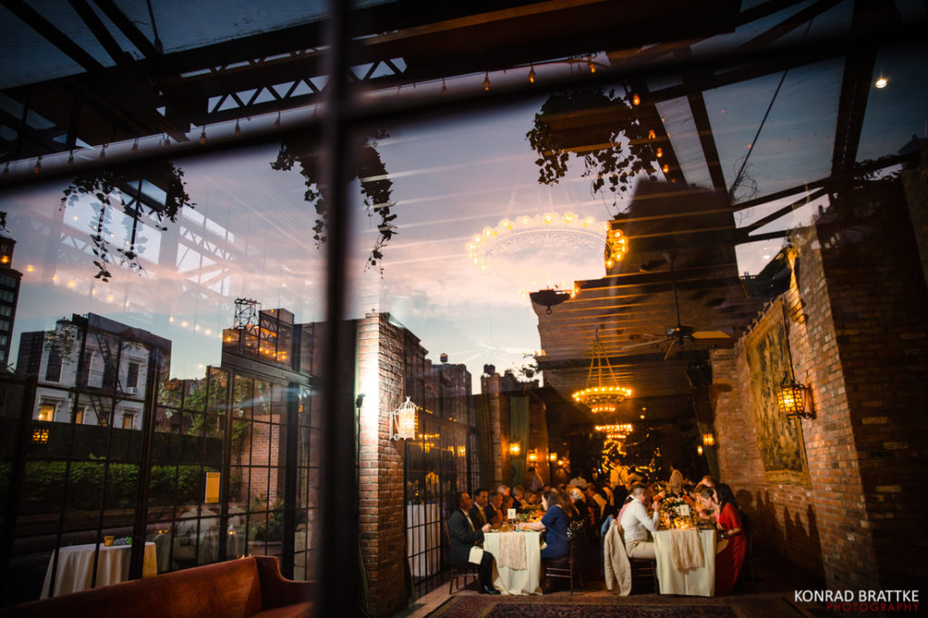 A wedding reception at the Bowery Hotel with a glass wall.