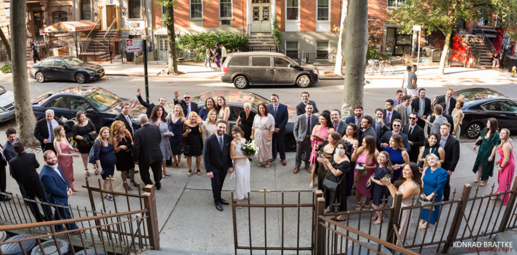 A group of people posing for a wedding group photo.