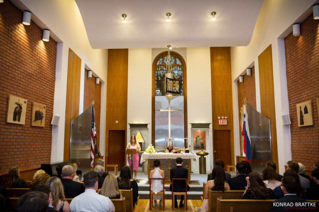 A group of people sitting in pews during a wedding ceremony at a church.