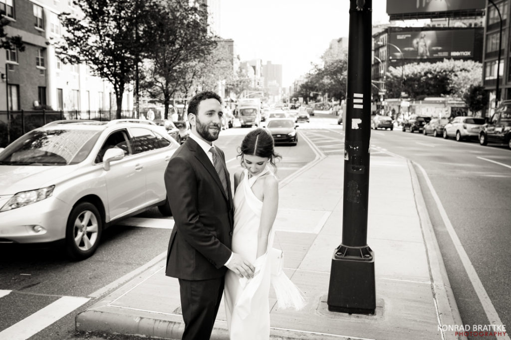 A bride and groom standing outside the Bowery Hotel on their wedding day.