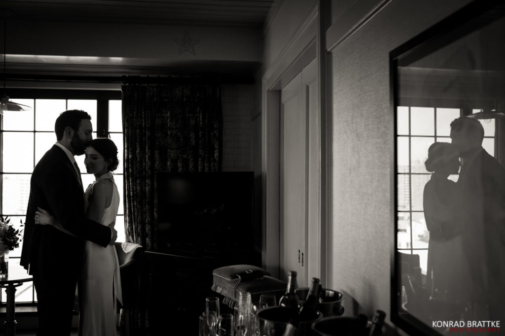 A bride and groom sharing a sweet moment of affection at their beautiful wedding in the charming Bowery Hotel.