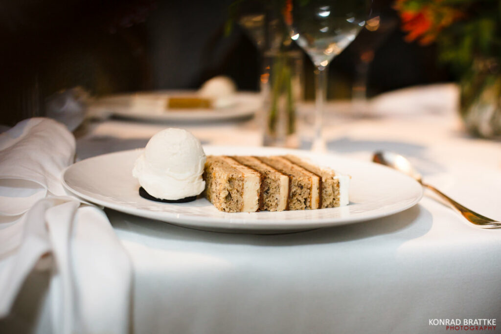 A plate with a slice of cake and ice cream.