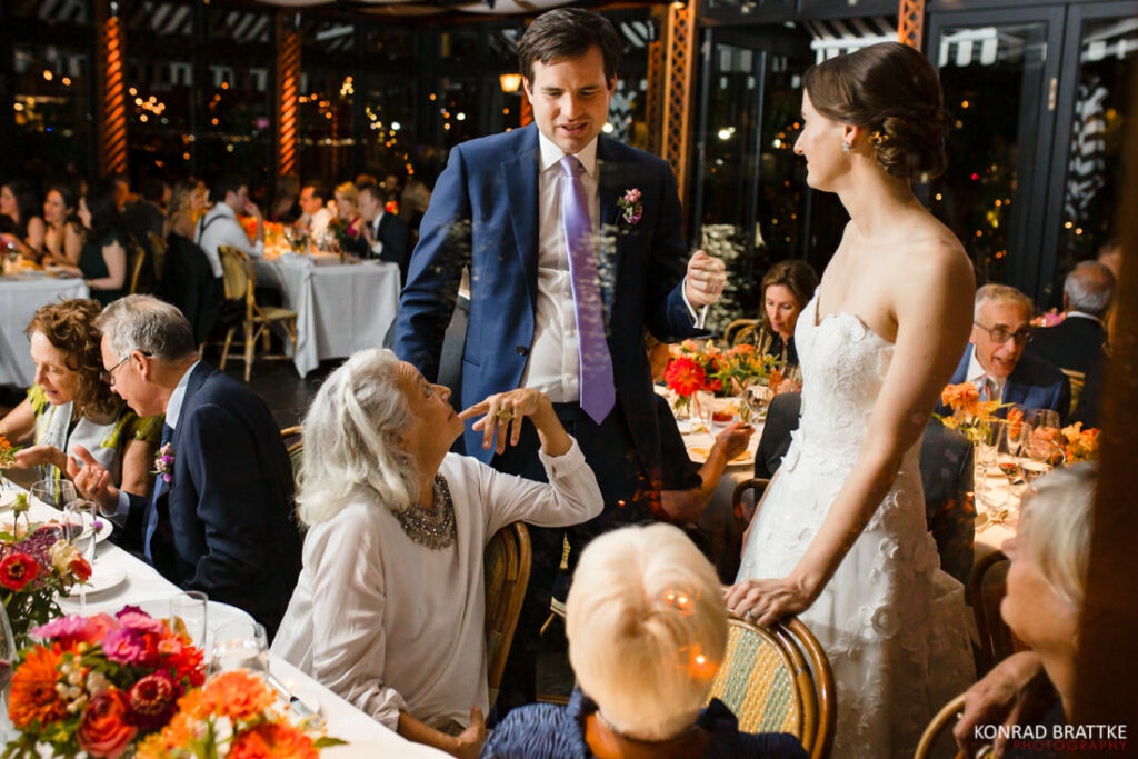 A bride and groom at a wedding reception at the river cafe.