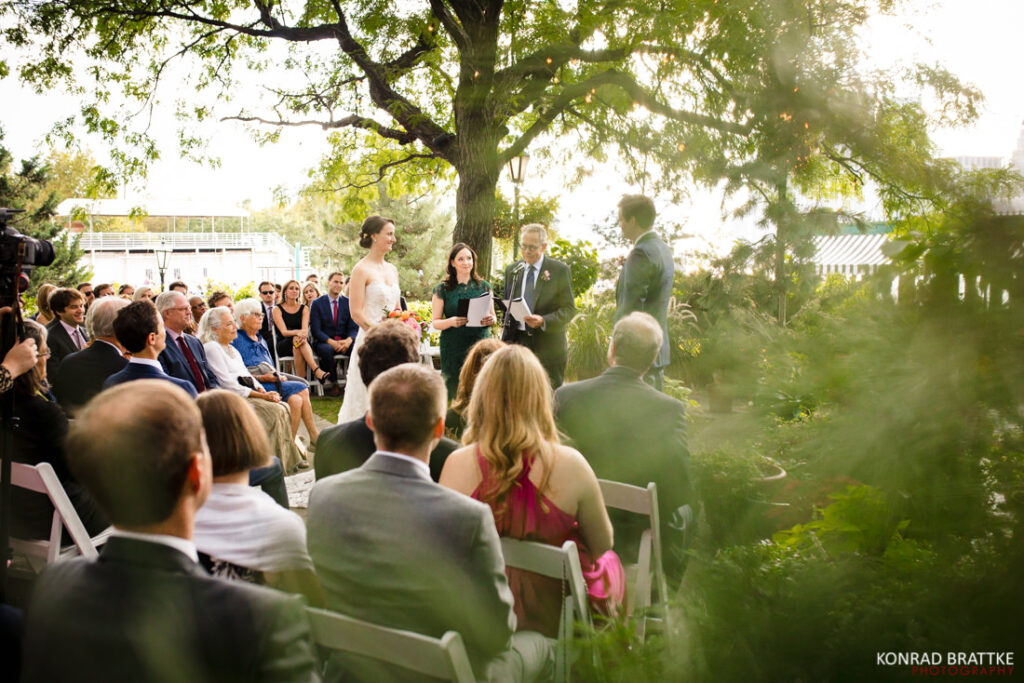 A wedding ceremony under a tree in the river cafe garden.