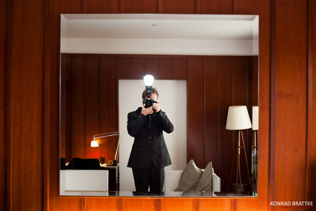 Self portrait by Konrad Brattke through a mirror. A Maryland wedding photographer.