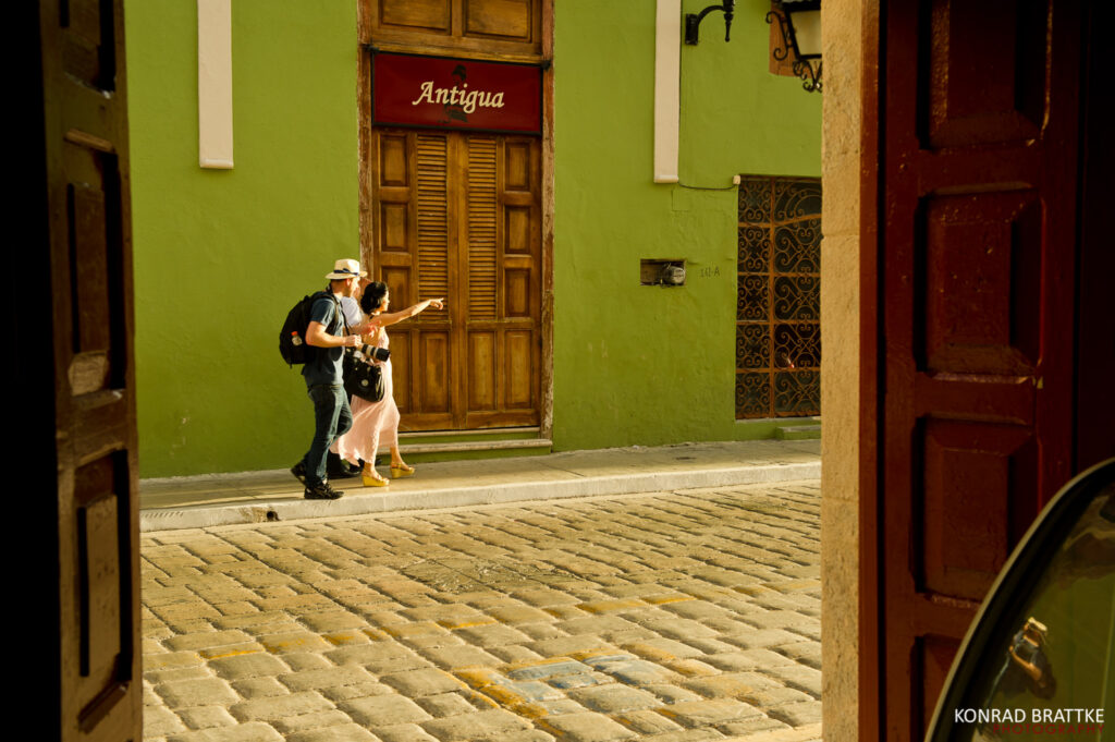 A couple walking down a cobblestone street captured by a Maryland wedding photographer.