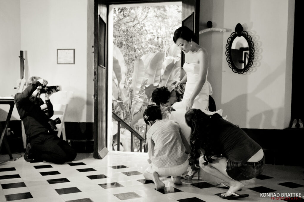 A bride is getting ready in front of a door, captured by a talented Maryland wedding photographer.